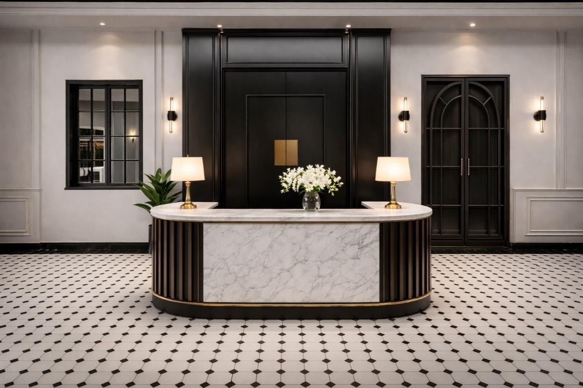 The arrival — a curved marble reception desk set against dark panelling.